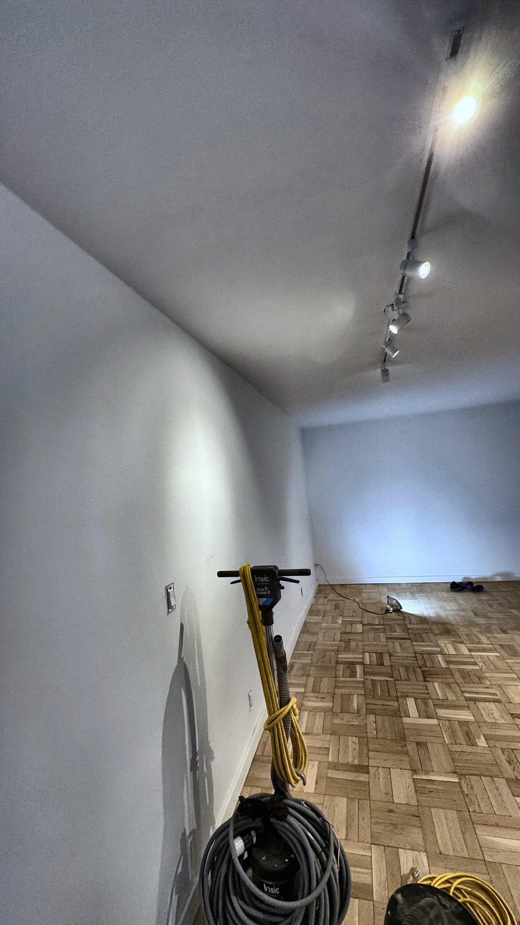 Hardwood floor refinishing in progress — process documentation from an Eron Renovations founder project