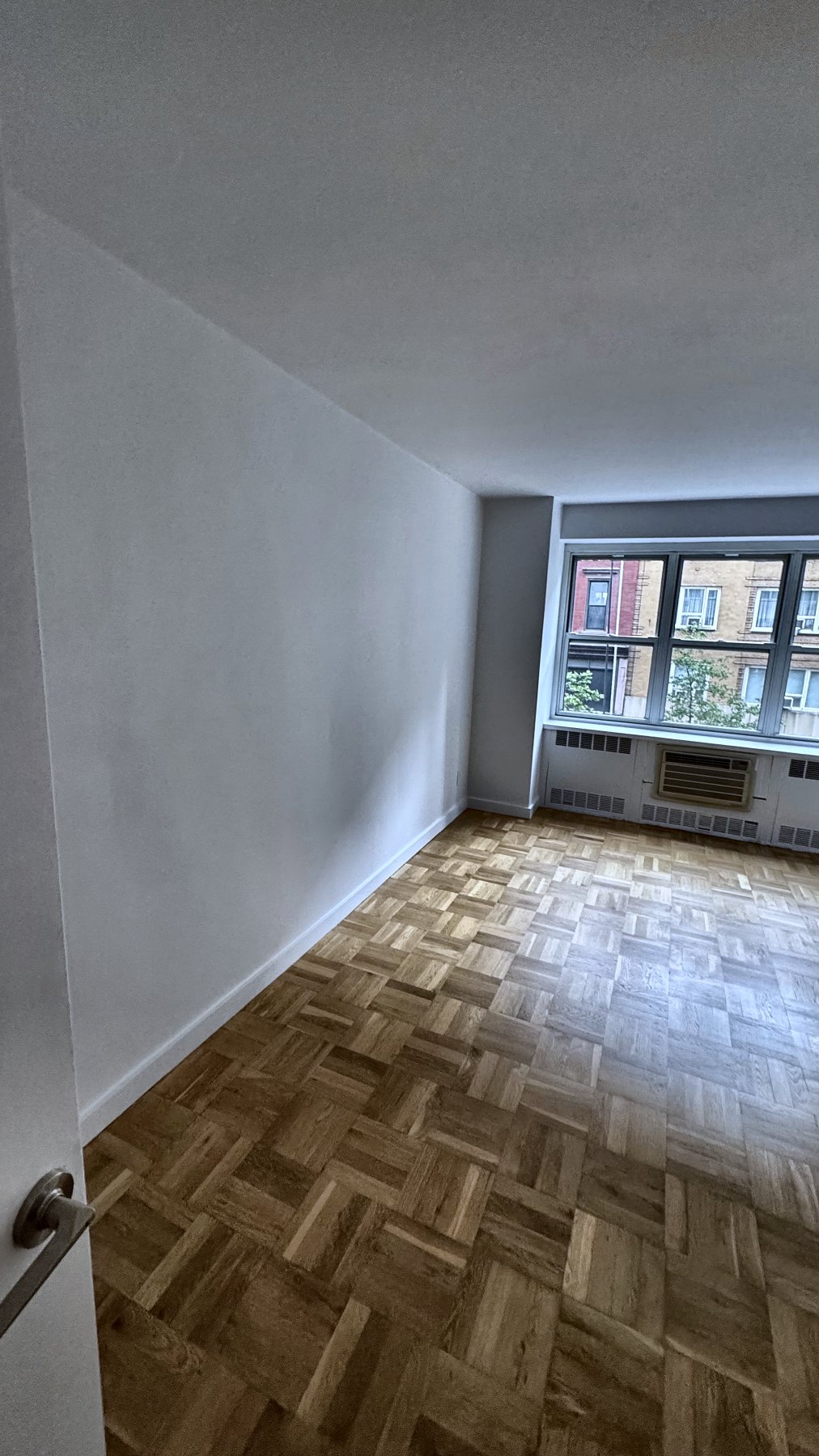 Freshly painted interior with refinished parquet floors — renovation work by the Eron Renovations founder